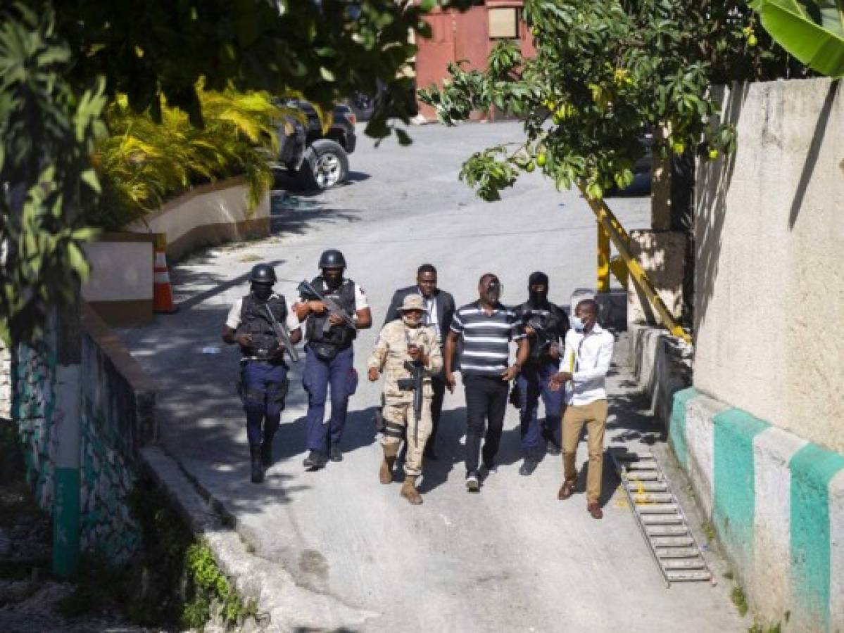 Security forces investigate the perimeters of the residence of Haitian President Jovenel Moise, in Port-au-Prince, Haiti, Wednesday, July 7, 2021. Gunmen assassinated Moise and wounded his wife in their home early Wednesday. (AP Photo/Joseph Odelyn)