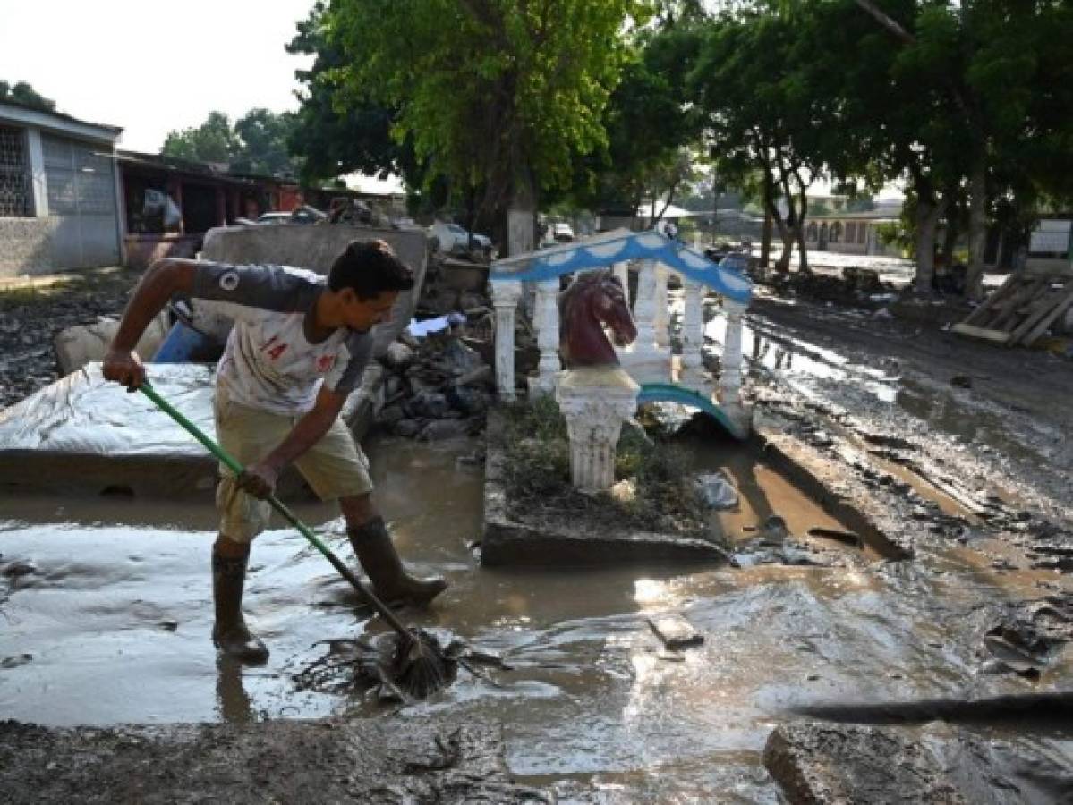 Algunas personas han llegado a sus viviendas a realizar labores de limpieza y a sacar las pertenencias afectadas. Foto: AFP