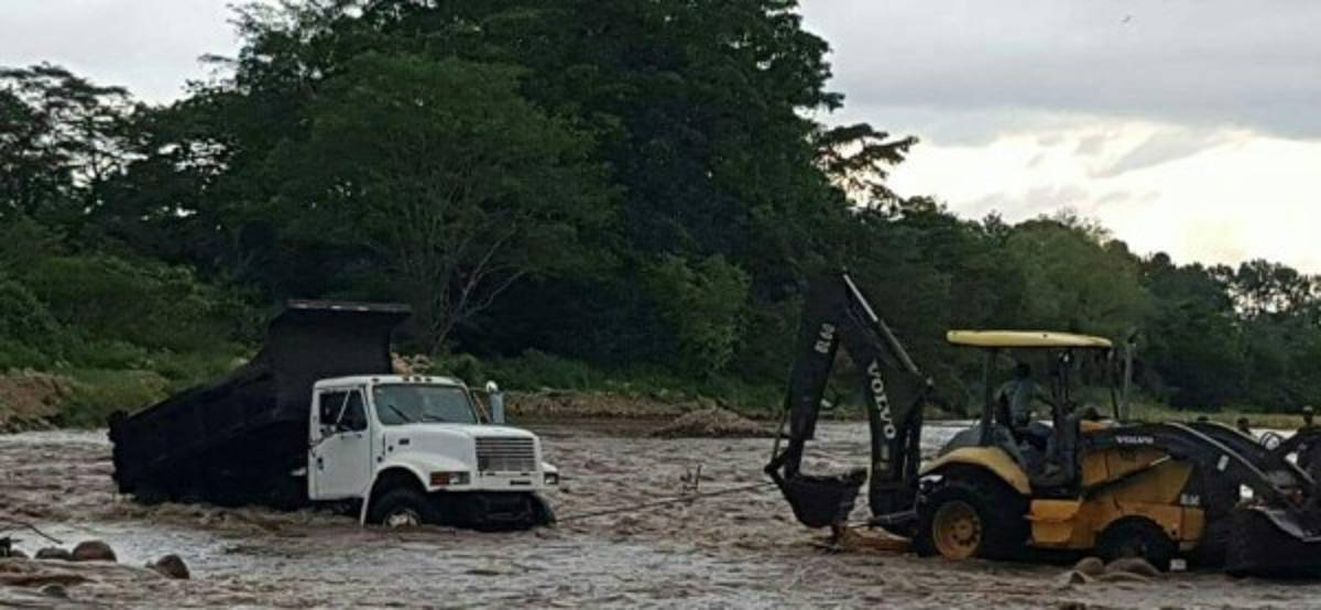 Una volqueta es remolcada de las fuertes corrientes de agua en Colón.