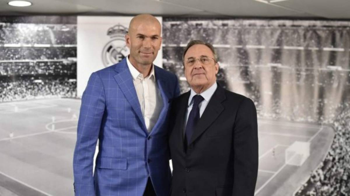 Real Madrid's new French coach Zinedine Zidane (L) poses with Real Madrid's president Florentino Perez after a statement at the Santiago Bernabeu stadium in Madrid on January 4, 2016. Rafael Benitez's unhappy reign in charge of Real Madrid came to an end after just seven months and 25 games when he was sacked and replaced by club legend Zinedine Zidane today. AFP PHOTO/ GERARD JULIEN / AFP / GERARD JULIEN