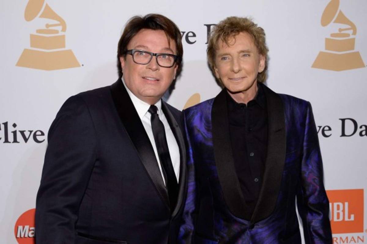 (FILES) This file photo taken on February 13, 2016 shows Garry Kief (L) and singer Barry Manilow attending the 2016 Pre-GRAMMY Gala and Salute to Industry Icons honoring Irving Azoff at The Beverly Hilton Hotel in Beverly Hills, California. Chart-topping singer Barry Manilow came out of the closet Wednesday, April5, 2017 at age 73, saying he kept silent on his nearly four-decade relationship with a man to avoid disappointing fans. Manilow, best known for his love ballad 'Mandy' and Latin-tinged pop number 'Copacabana (at the Copa)'), confirmed his sexuality two years after gossip media discovered his marriage to his manager Garry Kief. / AFP PHOTO / GETTY IMAGES NORTH AMERICA / KEVORK DJANSEZIAN