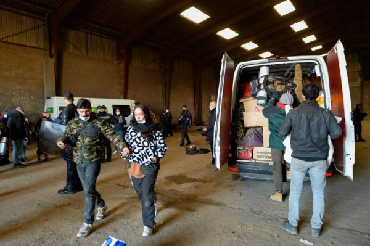 French Gendarmes evacuate the last partygoers who attended a rave in a disused hangar in Lieuron about 40km (around 24 miles) south of Rennes, on January 2, 2021. - Some 2,500 partygoers attended an illegal New Year rave in northwestern France, violently clashing with police who failed to stop it and sparking concern the underground event could spread the coronavirus, authorities said on January 1, 2021. Such mass gatherings are banned across France to prevent the spread of Covid-19, and a nationwide 8 pm curfew -- which was not lifted for New Year -- applies across the country. (Photo by JEAN-FRANCOIS MONIER / AFP)