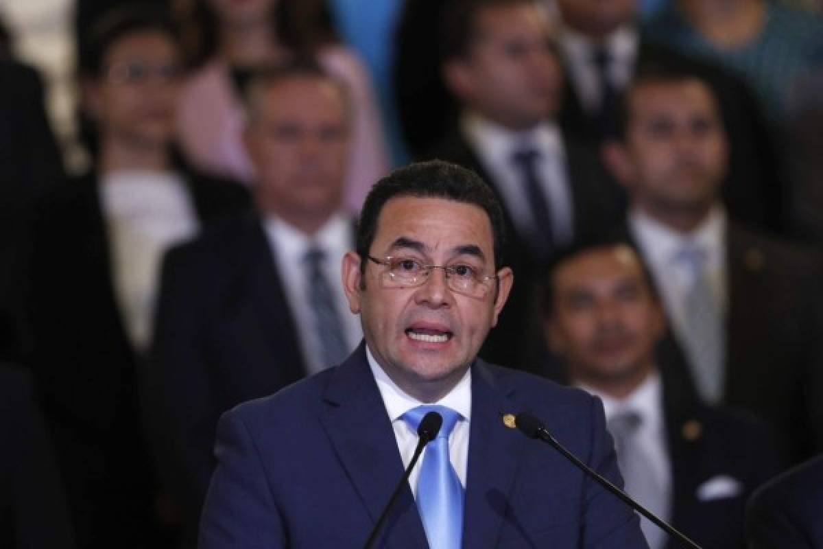 Guatemala's President Jimmy Morales, flanked by his cabinet, gives a statement at the National Palace in Guatemala City, Monday, Jan. 7, 2019. Guatemala announced that it is going to withdraw from UN-sponsored anti-corruption commission. (AP Photo/Moises Castillo)