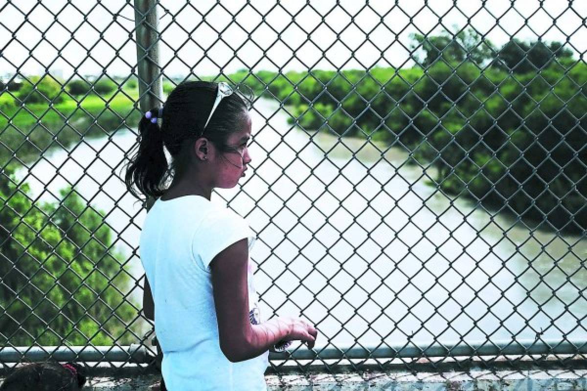 BROWNSVILLE, TX - JUNE 25: Yerlin Yessehia, 11, of Honduras waits with her family along the border bridge after being denied entry into the U.S. from Mexico on June 25, 2018 in Brownsville, Texas. Immigration has once again been put in the spotlight as Democrats and Republicans spar over the detention of children and families seeking asylum at the border. Before President Donald Trump signed an executive order last week that halts the practice of separating families who are seeking asylum, more than 2,300 immigrant children had been separated from their parents in the zero-tolerance policy for border crossers. Spencer Platt/Getty Images/AFP