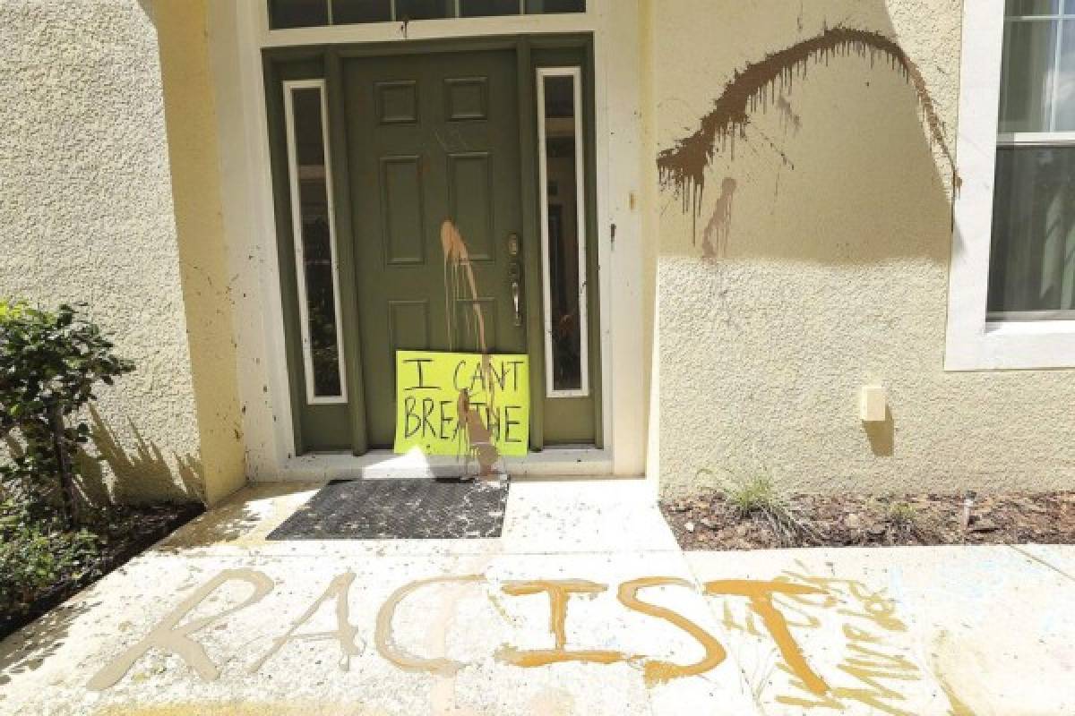 Protestera vandalized a townhouse owned by former Minneapolis police officer Derek Chauvin, Friday, May 29, 2020, in Windermere, Fla. Chauvin, who was seen on video kneeling on the neck of George Floyd, who died in custody after pleading that he couldn't breathe, was charged Friday with two of the same counts that led to a 12 1/2-year prison sentence for another former officer from his department. He was charged with third-degree murder and second-degree manslaughter.   (Stephen M. Dowell/Orlando Sentinel via AP)