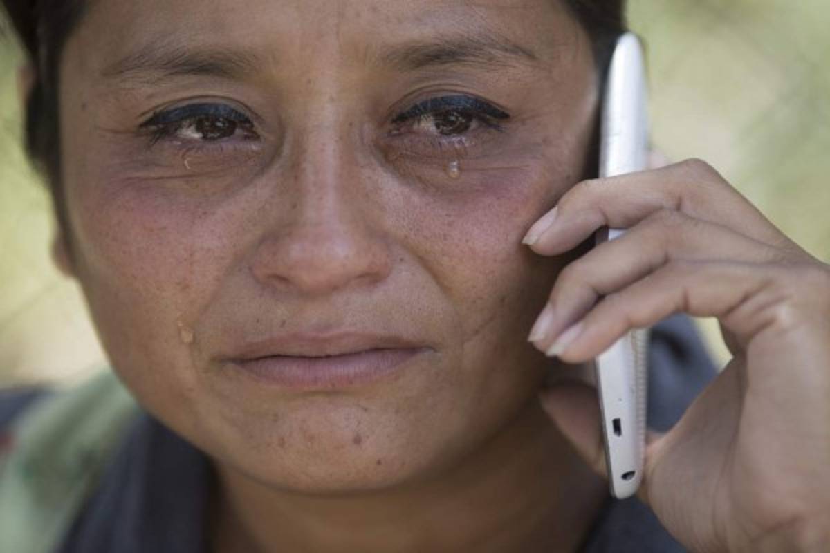 Tears roll down the cheeks of Claudia Tecun at the entrance of Guatemala City's Roosevelt Hospital where her 17-year-old daughter Noemi Tecun, a youth shelter fire victim, is being treated for burns that covered 70 percent of her body, Friday, March 10, 2017. Guatemala's president called for a restructuring of his country's youth shelter system following the fire that killed at least 36 girls at an overcrowded government facility for children. Relatives and officials said Wednesday's blaze began when youths set fire to mattresses to protest abuses at the Virgin of the Assumption Safe House. (AP Photo/Luis Soto)