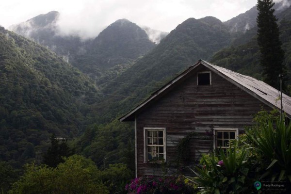 Abandoned ghost town from old Rosario Mines dating from 19th century on edge of La Tigra National Park with rainforest in background near Tegucigalpa Honduras