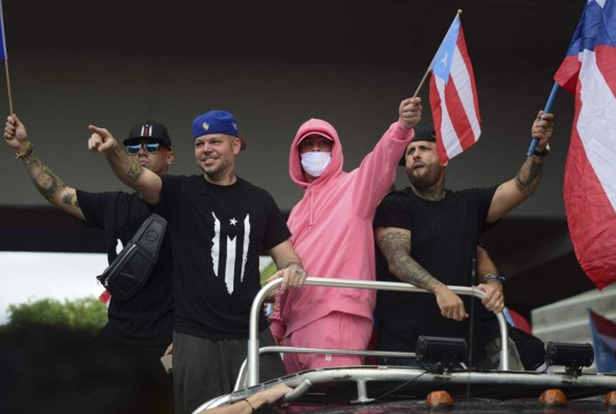 ARCHIVO â En esta fotografÃ­a de archivo del 25 de julio de 2019 Los cantantes urbanos Wisin, de izquierda a derecha, Residente, Bad Bunny y Nicky Jam en una marcha para celebrar la renuncia del gobernador Ricardo RossellÃ³ tras dos semanas de protestas por sus controvertidas declaraciones en un chat filtrado en San Juan, Puerto Rico. Residente celebrÃ³ la participaciÃ³n del pueblo puertorriqueÃ±o en las manifestaciones en entrevista con AP en la Ciudad de MÃ©xico en diciembre de 2019. (Foto AP/Carlos Giusti)