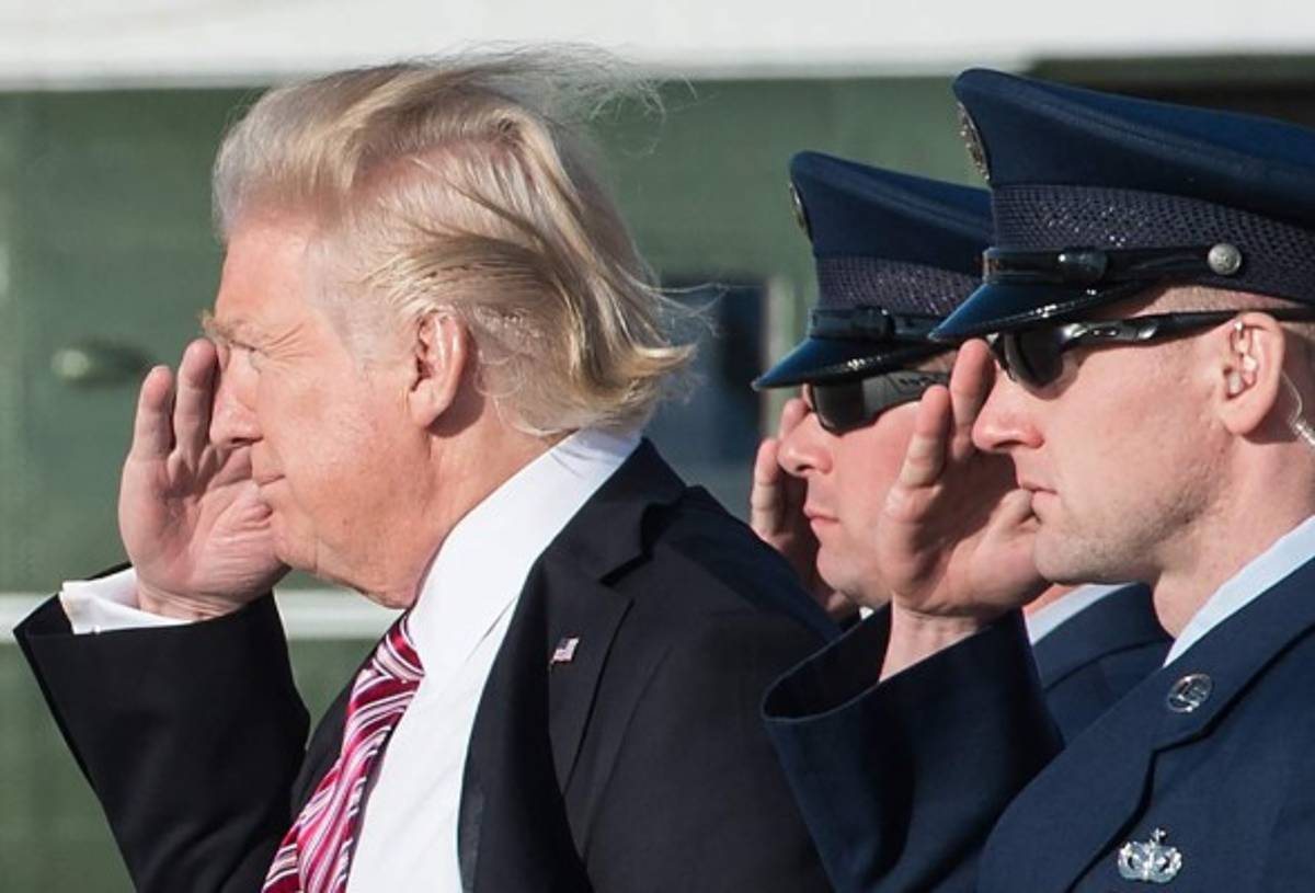 (FILES) US President Donald Trump salutes as he steps off Air Force One at Andrews Air Force Base in Maryland upon his return from Philadelphia on January 26, 2017.While the new US president has shown a capacity to change, both his tone and his positions, he has been unable to show the world a 'new' Trump, with a steady presidential style and a clearly articulated worldview. As the symbolic milestone of his 100th day in power, which falls on April 29, 2017, draws near, a cold, hard reality is setting in for the billionaire businessman who promised Americans he would 'win, win, win' for them. At this stage of his presidency, he is the least popular US leader in modern history (even if his core supporters are still totally behind him.) / AFP PHOTO / NICHOLAS KAMM / TO GO WITH AFP STORY, US-politics-Trump-100days