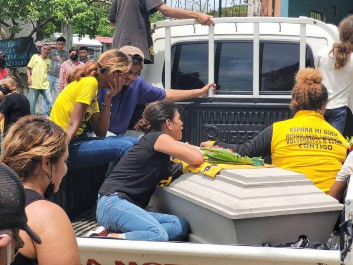 Familiares lloran sobre el ataúd de Wilson tras retirar su cuerpo de la morgue de San Pedro Sula.