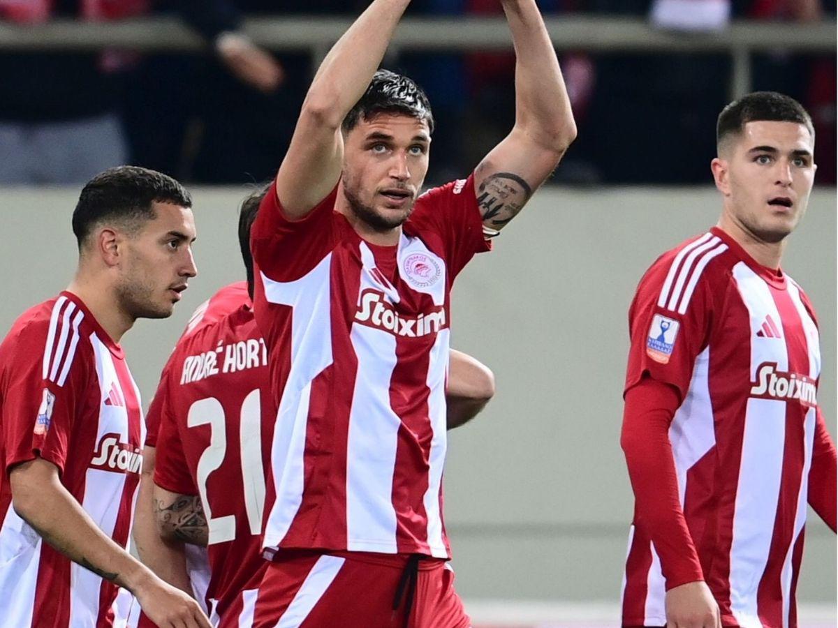 Luis Palma anota su primer gol con el Olympiacos y lo celebra frente a jugador mexicano