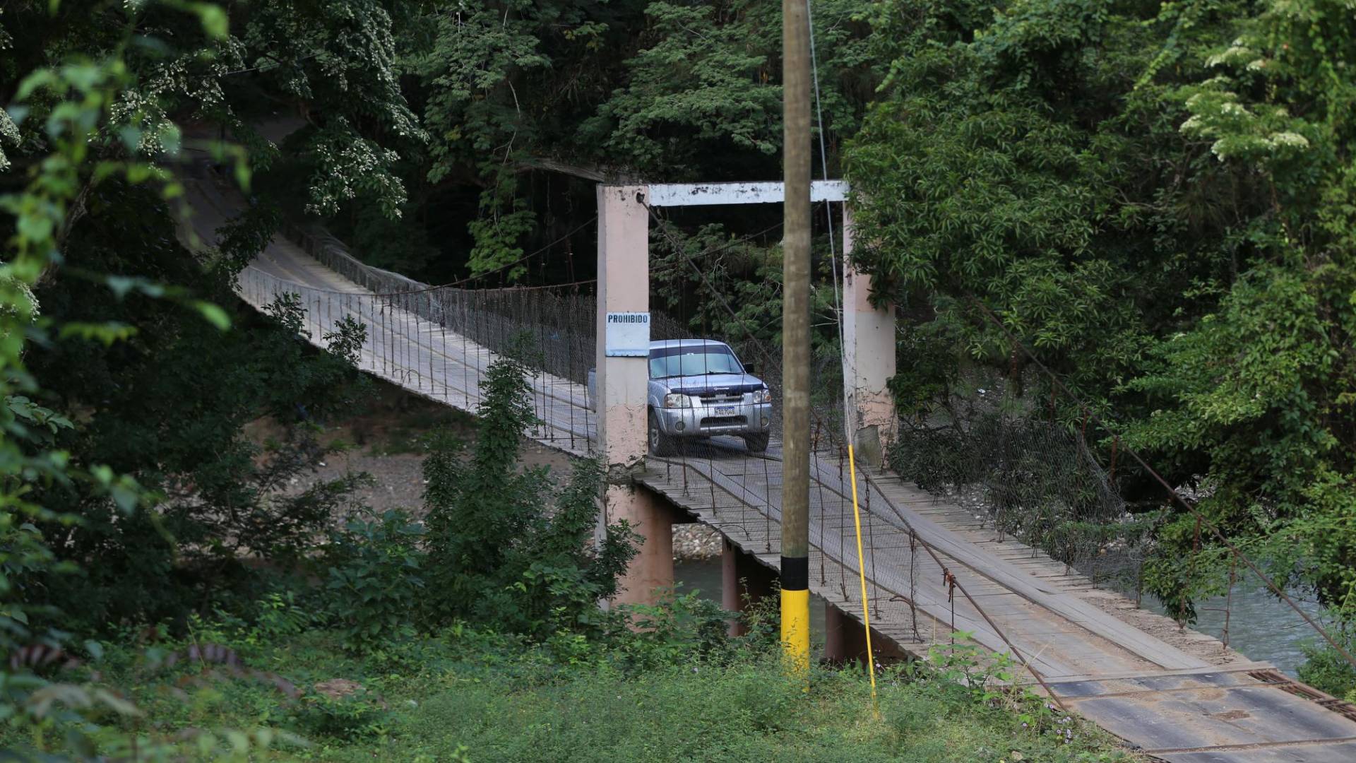 $!A pesar de tener un puente Bailey de 42 millones de lempiras tirado en un predio los habitantes de Ojos de Agua, los habitantes arriesgan su vida en un puente de hamaca