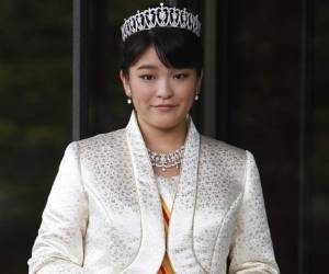 FILE - In this Oct. 23, 2011, file photo, Japan's Princess Mako, the first daughter of Prince Akishino and Princess Kiko, poses for photos at Imperial Palace in Tokyo. According to Japanese media, the Imperial Household Agency said Tuesday, Feb. 6, 2018 that Princess Mako's wedding, planned for November, will be delayed until 2020, citing lack of time for preparations. (AP Photo/Shizuo Kambayashi, File)