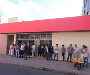 Clientes hacen cola en una agencia bancaria en Tegucigalpa. (Foto: David Romero)
