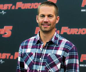 FILE - In this April 29, 2011 file photo, actor Paul Walker poses during the photo call of the movie 'Fast and Furious 5,' in Rome. Universal Pictures has shut down production on ?Fast & Furious 7? indefinitely following the death of its star, Walker. The studio announced Wednesday, Dec. 4, 2013, that the film will shut down ?for a period of time so we can assess all options available to move forward with the franchise.? (AP Photo/Andrew Medichini, File)