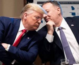 (FILES) In this file photo taken on May 29, 2020, US President Donald Trump, with Secretary of State Mike Pompeo, holds a press conference in the Rose Garden of the White House in Washington, DC. - Trump on December 19, 2020, downplayed a massive cyberattack on US government agencies, declaring it 'under control' and undercutting the assessment by his own administration that Russia was to blame. Trump's response came a day after Pompeo said in an interview that the attack -- which cyber experts say could have far-reaching impact and take months to unravel -- was 'pretty clearly' Russia's work. (Photo by MANDEL NGAN / AFP)