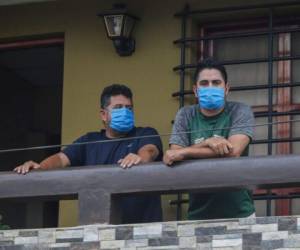 Norman Cardoze, a la izquierda, y su hijo Norman Cardoze Jr. posan para una foto desde el balcón de su casa donde están en cuarentena después de contraer el nuevo coronavirus en Managua, Nicaragua. Foto: AP
