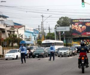 Policías de Tránsito dando vía debajo de semáforo que está funcionando.