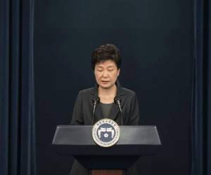 A boy wearing a face mask sits on a suitcase at a railway station in Daegu on February 26, 2020. - An American soldier stationed in South Korea has tested positive for the COVID-19 coronavirus, commanders said on February 26, as the country's case total jumped again. Meanwhile, South Korean authorities reported 169 new infections, taking the overall national tally to 1,146, by far the largest outside China. (Photo by Jung Yeon-je / AFP)