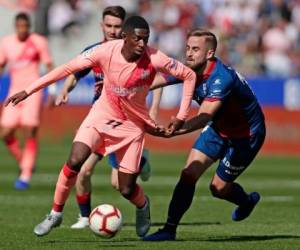 Ousmane Dembele, izquierda, lucha por el balón con Jorge Pulido de Huesca durante el partido de fútbol de la Liga española entre Huesca y Barcelona en el estadio Alcoraz de Huesca, sábado 13 de abril de 2019. (Foto AP / Manu Fernández)