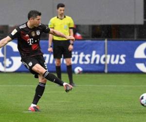 Bayern Munich's Polish forward Robert Lewandowski scores the opening goal from the penalty spot, his 40th goal of the season during the German first division Bundesliga football match between SC Freiburg and FC Bayern Munich in Freiburg, southwestern Germany on May 15, 2021. (Photo by Thomas KIENZLE / POOL / AFP) / DFL REGULATIONS PROHIBIT ANY USE OF PHOTOGRAPHS AS IMAGE SEQUENCES AND/OR QUASI-VIDEO