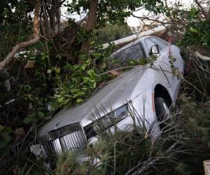 Un Bentley dañado por la tormenta descansa contra un árbol tras el paso del huracán Ian el 1 de octubre de 2022 en Bonita Springs, Florida.