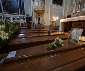 Coffins wait to be transported to cemetery, in the church of Serina, near Bergamo, Northern Italy, Saturday, March 21, 2020. Italyâs tally of coronavirus cases and deaths keeps rising, with new day-to-day highs: 793 dead and 6,557 new cases. For most people, the new coronavirus causes only mild or moderate symptoms. For some it can cause more severe illness. (Claudio Furlan/LaPresse via AP)