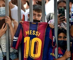 Fans outside the Camp Nou stadium where Barcelona's Argentinian forward Lionel Messi held a press conference in Barcelona on August 8, 2021. - Messi fought back tears as he began a press conference at which he confirmed he is leaving Barcelona, where he has played his entire career. (Photo by Pau BARRENA / AFP)