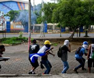 Picture of the facade of '100% Noticias' (100% News) televison station in Managua, taken on December 22, 2018 a day after it was raided and closed by the Nicaraguan Police. - The director of 100% Noticias, Miguel Mora, was arrested during the raid. Rights groups say at least 320 people have been killed in Nicaragua in a brutal government crackdown launched in response to the escalation in April of street protests, initially against a now-ditched pension reform. (Photo by MAYNOR VALENZUELA / AFP)