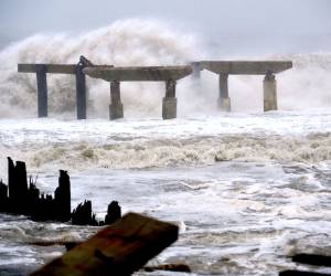 Waves crash against a previously damaged pier before landfall of Hurricane Sandy October 29, 2012 in Atlantic City, New Jersey. Storm-driven waves crashed ashore and flooded seafront communities across a swathe of the eastern United States as Hurricane Sandy barreled towards land. Officials warned that the threat to life and property was 'unprecedented' and ordered hundreds of thousands of residents in cities and towns from New England to North Carolina to evacuate their homes and seek shelter. AFP PHOTO/Stan HONDA
