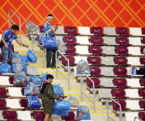 Con bolsas plásticas fueron captadas los aficionados de Japón, que se quedaron limpiando el estadio Internacional Jalifa.