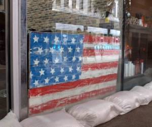Sandbags line store front of a barber shop in preparation for tropical storm Barry in New Orleans, Louisiana, on July 11, 2019. - Tropical storm Barry barreled toward rain-soaked New Orleans on July 11 as the city hunkered down for an ordeal that evoked fearful memories of 2005's deadly Hurricane Katrina. Barry is predicted to become a Category 1 hurricane before making landfall Saturday with maximum winds reaching 75 mph. (Photo by Seth HERALD / AFP)