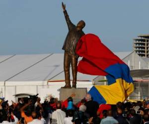 FILE - In this Sept. 16, 2016 file photo, a three-meter bronze statue of Venezuela's late President Hugo Chavez is unveiled at the 17th Non Aligned Summit, a meeting held by a Cold War-era group of 120 nations, in Porlamar on Margarita Island, Venezuela. As anti-government unrest has spread, claiming at least 48 lives and leaving hundreds injured, protesters have ripped from their pedestals statues honoring Chavez in at least five towns over the past month of May 2017. (AP Photo/Ariana Cubillos, File)
