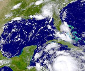 This NASA GOES Project satellite image shows a GOES-East satellite photo of Tropical Storm Ernesto(bottom) in the Atlantic on August 6, 2012. The US National Hurricane Center in Florida said tropical storm conditions were possible along the coast of Honduras by late Monday. A tropical storm watch advisory was also issued for Grand Cayman. Ernesto was following a predicted track that should keep it at sea until a forecast landfall, possibly at hurricane strength, over Mexico's Yucatan peninsula on Wednesday. The storm was 235 miles (375 km) east of the coast of Honduras at around 11 p.m. EDT (0300 GMT) on Sunday, moving west at about 15 mph (24 kph) with maximum sustained winds around 50 mph (85 kph). AFP PHOTO/HANDOUT/NOAA = RESTRICTED TO EDITORIAL USE - MANDATORY CREDIT ' AFP PHOTO / Pima County Sheriff's Department ' - NO MARKETING NO ADVERTISING CAMPAIGNS - DISTRIBUTED AS A SERVICE TO CLIENTS =