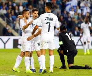 Israel's midfielder Dia Saba (L) celebrates with his teammates after scoring against Guatemala during the FIFA friendly football match between Israel and Guatemala at Netanya Municipal Stadium in the Israeli coastal city of Netanya on November 15, 2018. (Photo by JACK GUEZ / AFP)