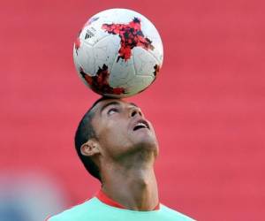 Portugal's Cristiano Ronaldo looks down in the shadow during a training session at the Arena in Kazan, Russia, on Saturday, June 17, 2017. Portugal will play Mexico in a Confederations Cup, Group A soccer match scheduled for Sunday, June 18, 2017. (AP Photo/Martin Meissner)