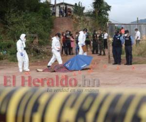 Vecinos observan temerosos la triste escena del crimen. Foto: Estalin Irías/ EL HERALDO.