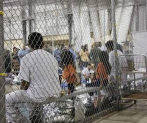 FILE - In this June 17, 2018 file photo provided by U.S. Customs and Border Protection, people who've been taken into custody related to cases of illegal entry into the United States, sit in one of the cages at a facility in McAllen, Texas. The Trump administration is under increasing pressure to speed up the reunification of immigrant families it separated at the Mexican border. Attorneys for the U.S. government and the immigrant families discussed how to accelerate the process at a hearing Friday, Aug. 31, 2018, in San Diego in front of U.S. District Judge Dana Sabraw, who set the deadline. (U.S. Customs and Border Protection's Rio Grande Valley Sector via AP, File)