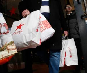 Una persona sale de una tienda de Macy's de Boston con varias bolsas el 29 de noviembre del 2019.