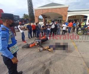 El cuerpo del joven y su vehículo quedaron en pleno estacionamiento frente al comercio.