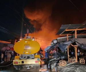 Un devorador incendio que inició en un negocio de cohetes consumió la mayoría de puestos ubicados en la calle 6, en el barrio Medina, en la ciudad de San Pedro Sula, registrado durante este lunes 29 de diciembre.
