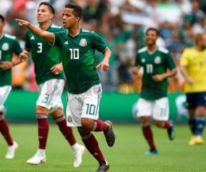 Dos Santos celebra el gol que le anotó con México a Escocia. Foto: Agencia AFP.