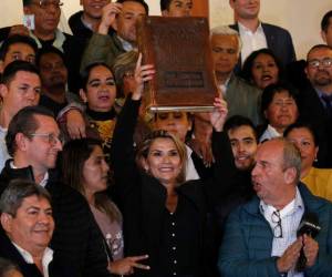 (FILES) In this file photo taken on March 13, 2021 former interim Bolivia's President Jeanine Anez speaks with her lawyers in a prison cell of the Special Force for the Fight Against Crime (FELCC) after being arrested in La Paz. - Anez suffered a decompensation on March 17, 2021 at a jail in La Paz where she remains in pretrial detention while she is investigated for an alleged coup against Bolivian former President Evo Morales in 2019. (Photo by LUIS GANDARILLAS / AFP)