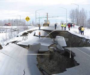 Workers inspect an off-ramp that collapsed during a morning earthquake, Friday, Nov. 30, 2018, in Anchorage, Alaska. (AP Photo/Mike Dinneen)