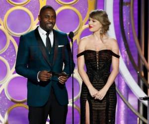 En esta imagen difundida por NBC, Idris Elba y Taylor Swift presentan un premio durante la gala de los Globos de Oro, el domingo 6 de enero del 2019 en Beverly Hills, California.
