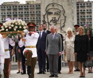 Tras una imagen del Che Guevara, el príncipe Carlos de Gran Bretaña, y Camilla, duquesa de Cornualles asisten a una ceremonia de ofrenda floral en el Monumento a José Martí durante su visita oficial a La Habana. (Foto: AP)