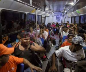 Los migrantes centroamericanos, en su mayoría hondureños, que se desplazan en caravana hacia Estados Unidos, abordan el autobús en la estación fitosanitaria de La Concha en el estado mexicano de Sinaloa. Agencia AFP.