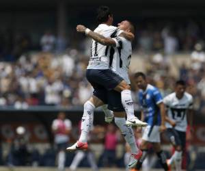 Pumas' Matias Alustiza, left, celebrates his goal against Queretaro with teammate Nicolas Castillo during a Mexico soccer league match in Mexico City, Sunday, April 29, 2018. Pumas and Queretaro tied 1-1. (AP Photo/Eduardo Verdugo)