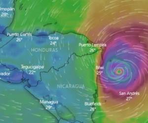 A man watches the rising waters of the Rio Bermejo in the wake of Hurricane Iota in San Pedro Sula, Honduras, Tuesday, Nov. 17, 2020. Hurricane Iota tore across Nicaragua on Tuesday, hours after roaring ashore as a Category 4 storm along almost exactly the same stretch of the Caribbean coast that was recently devastated by an equally powerful hurricane. (AP Photo/Delmer Martinez)