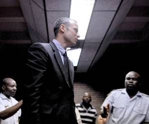 TOPSHOTS South Africa's Olympic sprinter Oscar Pistorius leaves the court room after his hearing on charge of murdering his model girlfriend Reeva Steenkamp on Valentine's Day, yesterday, on February 15, 2013 at the Magistrate Court in Pretoria. South African prosecutors will argue that Pistorius is guilty of premeditated murder in Steenkamp's death, a charge which could carry a life sentence. AFP PHOTO / STEPHANE DE SAKUTIN